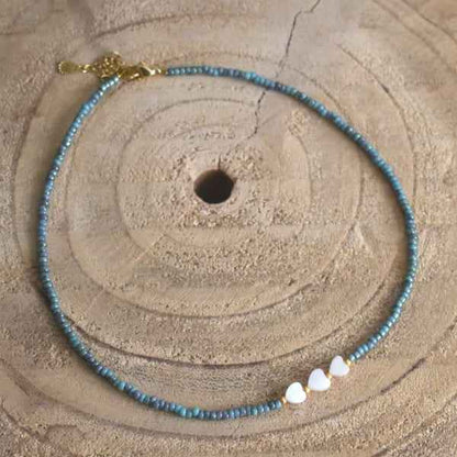 Turquoise Miyuki kralen ketting staal kort dames met parelmoer hartjes - Idhuna Jewels